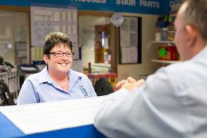 A James Donaldson Group employee smiling as she talks to another member of staff