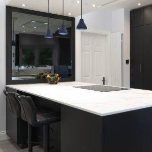 A photo of a Kitchen's International kitchen with white marble surface and black cabinets